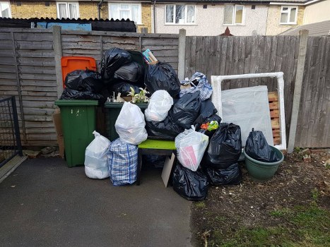 Rubbish collection team loading waste in a Putney residential street