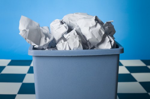 Trained rubbish removal staff handling waste with care in Putney