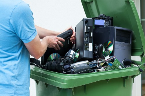 Rubbish removal team loading waste into a collection vehicle