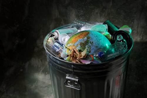 Waste removal operatives handling items at a property entrance